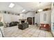 Bright living room showcasing a stone fireplace, high ceilings, skylights, and tile flooring at 4346 Thomas Wood Ln E, Winter Haven, FL 33880