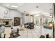Open concept living room with stone fireplace, high ceilings, and tile flooring at 4346 Thomas Wood Ln E, Winter Haven, FL 33880