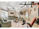 Relaxing living room featuring tile floors, multiple ceiling fans, comfortable seating and gym equipment at 4346 Thomas Wood Ln E, Winter Haven, FL 33880