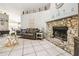 Living room with stone fireplace, tile flooring, and decorative accents at 4346 Thomas Wood Ln E, Winter Haven, FL 33880
