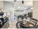 Open-concept living and dining area features tile floors and a cozy living space with a fireplace at 4346 Thomas Wood Ln E, Winter Haven, FL 33880