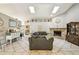 Spacious living room featuring high ceilings, skylights, stone fireplace, and tile flooring at 4346 Thomas Wood Ln E, Winter Haven, FL 33880