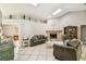 Cozy living room with tile floors, stone fireplace, and access to other rooms at 4346 Thomas Wood Ln E, Winter Haven, FL 33880