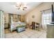 Cozy main bedroom with a stylish four-poster bed and tiled floors at 4346 Thomas Wood Ln E, Winter Haven, FL 33880