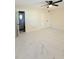 Open bedroom features marble floors, ceiling fan, closet, bathroom access, and bright natural light at 635 Mccormick St, Daytona Beach, FL 32114