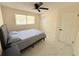 Bright bedroom with marble floors, ceiling fan, closet, and natural light from the window at 635 Mccormick St, Daytona Beach, FL 32114