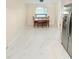 Sunny dining room with white marble floors and a wood dining table at 635 Mccormick St, Daytona Beach, FL 32114