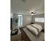 Bright bedroom featuring wood floors, white walls, ceiling fan, and shuttered windows at 1105 Chichester St, Orlando, FL 32803