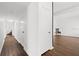 Bright hallway featuring hardwood floors and freshly painted white walls at 1105 Chichester St, Orlando, FL 32803