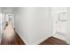 Hallway leading to bathroom with white cabinetry and neutral tile at 1105 Chichester St, Orlando, FL 32803