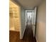 Hallway with hardwood floors leads to a walk in closet and the rest of the home at 1105 Chichester St, Orlando, FL 32803