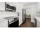 Modern kitchen featuring white cabinets, stainless steel appliances, and quartz counters at 1105 Chichester St, Orlando, FL 32803