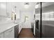 Modern kitchen featuring white cabinets, stainless steel appliances, and quartz counters at 1105 Chichester St, Orlando, FL 32803