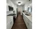 Modern kitchen features white cabinets, stainless steel appliances, and quartz countertops at 1105 Chichester St, Orlando, FL 32803