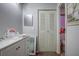 Bathroom featuring a well-lit vanity with a square mirror and a separate toilet area at 56 Pine Trak # 101E, Ocala, FL 34472