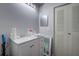 Bathroom features a well-lit vanity, a mirror, and a linen closet for ample storage at 56 Pine Trak # 101E, Ocala, FL 34472