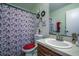 Bathroom with vanity, sink, a decorative mirror, and Paris-themed shower curtain at 56 Pine Trak # 101E, Ocala, FL 34472