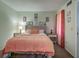 Comfortable bedroom with a queen bed, calming wall art, and warm colored curtains at 56 Pine Trak # 101E, Ocala, FL 34472