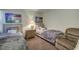Cozy bedroom featuring two twin beds, a comfortable recliner, and a central nightstand at 56 Pine Trak # 101E, Ocala, FL 34472