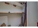 Interior view of closet with a few shelves, some debris, and other stored items at 56 Pine Trak # 101E, Ocala, FL 34472