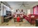 Inviting living room featuring a vaulted ceiling, tile floors, and comfortable seating at 56 Pine Trak # 101E, Ocala, FL 34472