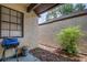 Enclosed patio area features a grill, textured walls, and a covered section for outdoor relaxation at 56 Pine Trak # 101E, Ocala, FL 34472