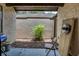 Enclosed patio featuring a young tree, textured walls, and a covered area for outdoor relaxation at 56 Pine Trak # 101E, Ocala, FL 34472