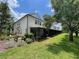 View of backyard area, with screened in patios, grassy areas and mature trees and landscaping at 6059 Twain St # 108, Orlando, FL 32835