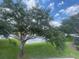 Backyard has a picturesque lake view with lush green grass and beautiful trees at 6059 Twain St # 108, Orlando, FL 32835
