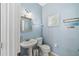 Charming powder room with pedestal sink and updated fixtures under soft natural light at 6059 Twain St # 108, Orlando, FL 32835
