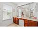 Primary bathroom with double sinks and a large framed mirror above vanity at 6059 Twain St # 108, Orlando, FL 32835