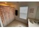 Cozy bathroom featuring a shower with floral curtain and a single vanity with a brown cabinet at 6059 Twain St # 108, Orlando, FL 32835