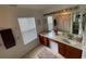 Bathroom boasts double sinks, a large mirror, and floral arrangements for a spa-like experience at 6059 Twain St # 108, Orlando, FL 32835