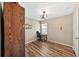 Bedroom featuring a desk, light fixture, and wood-look flooring at 6059 Twain St # 108, Orlando, FL 32835