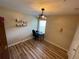 Comfortable bedroom with wood-look flooring, a large window and an industrial style ceiling fan at 6059 Twain St # 108, Orlando, FL 32835