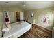 Bedroom with a bright window and a ceiling fan, with a bed and dresser at 6059 Twain St # 108, Orlando, FL 32835
