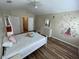 Bright bedroom with a vaulted ceiling, wood flooring, and ensuite bathroom and closet at 6059 Twain St # 108, Orlando, FL 32835