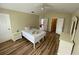 This bedroom features hardwood floors, a ceiling fan, and neutral colored walls at 6059 Twain St # 108, Orlando, FL 32835