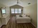 Bright bedroom with vaulted ceiling, ceiling fan, and hardwood flooring at 6059 Twain St # 108, Orlando, FL 32835