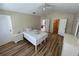 Bright bedroom with hardwood flooring and access to a bathroom and closet at 6059 Twain St # 108, Orlando, FL 32835