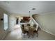 Open dining area with tile floors, round table, and direct access to the kitchen with stainless steel appliances at 6059 Twain St # 108, Orlando, FL 32835
