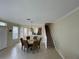 The dining area is adjacent to the kitchen and features a unique light fixture above the table at 6059 Twain St # 108, Orlando, FL 32835