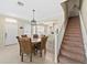 Dining room featuring a table, staircase, and views of the kitchen at 6059 Twain St # 108, Orlando, FL 32835
