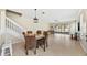 Open-concept dining room features tile floors, a modern light fixture, and views of the backyard at 6059 Twain St # 108, Orlando, FL 32835