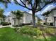Charming townhome with a well-maintained lawn, attractive landscaping, and a beautiful mature shade tree at 6059 Twain St # 108, Orlando, FL 32835