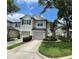 Exterior shot of townhomes with well-manicured lawns and driveways at 6059 Twain St # 108, Orlando, FL 32835