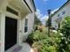 Beautiful front door with tasteful landscaping and welcoming entrance, and a view of the pond nearby at 6059 Twain St # 108, Orlando, FL 32835