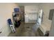 Well-lit garage with storage shelving, utility closet, and a convenient mudroom entryway at 6059 Twain St # 108, Orlando, FL 32835
