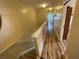 Upstairs hallway featuring hardwood floors and access to bedrooms and bathrooms at 6059 Twain St # 108, Orlando, FL 32835