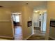 Hallway with views of a home office and bedroom, with laminate flooring and neutral paint at 6059 Twain St # 108, Orlando, FL 32835